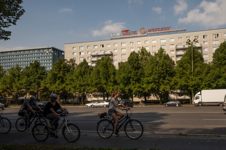 a group of people riding on the back of a bicycle