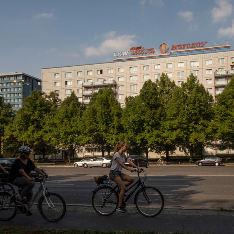 a group of people riding on the back of a bicycle