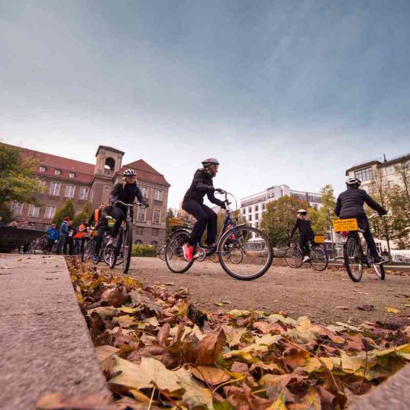 a man riding a bike down a dirt road