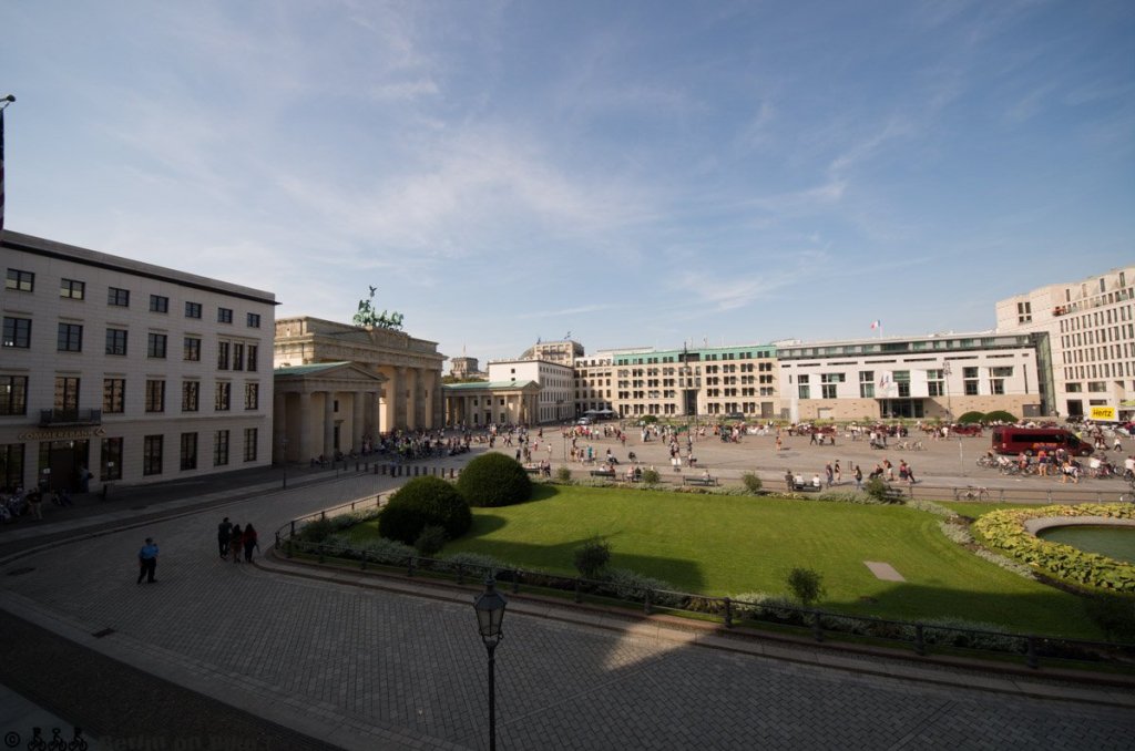 a large building with a clock on the side of a road