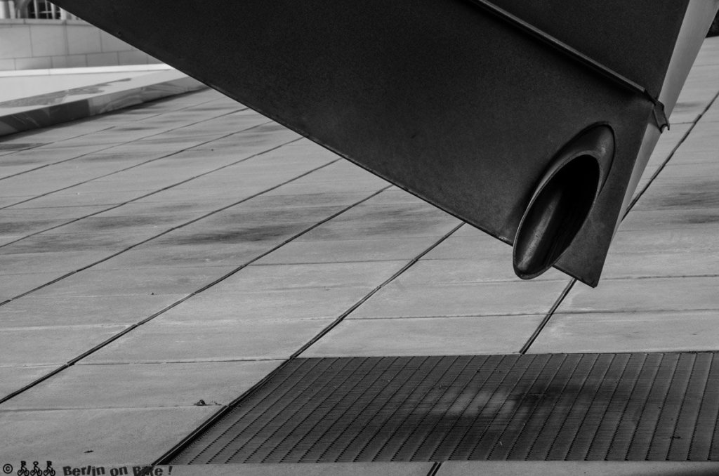 a plane sitting on top of a sidewalk