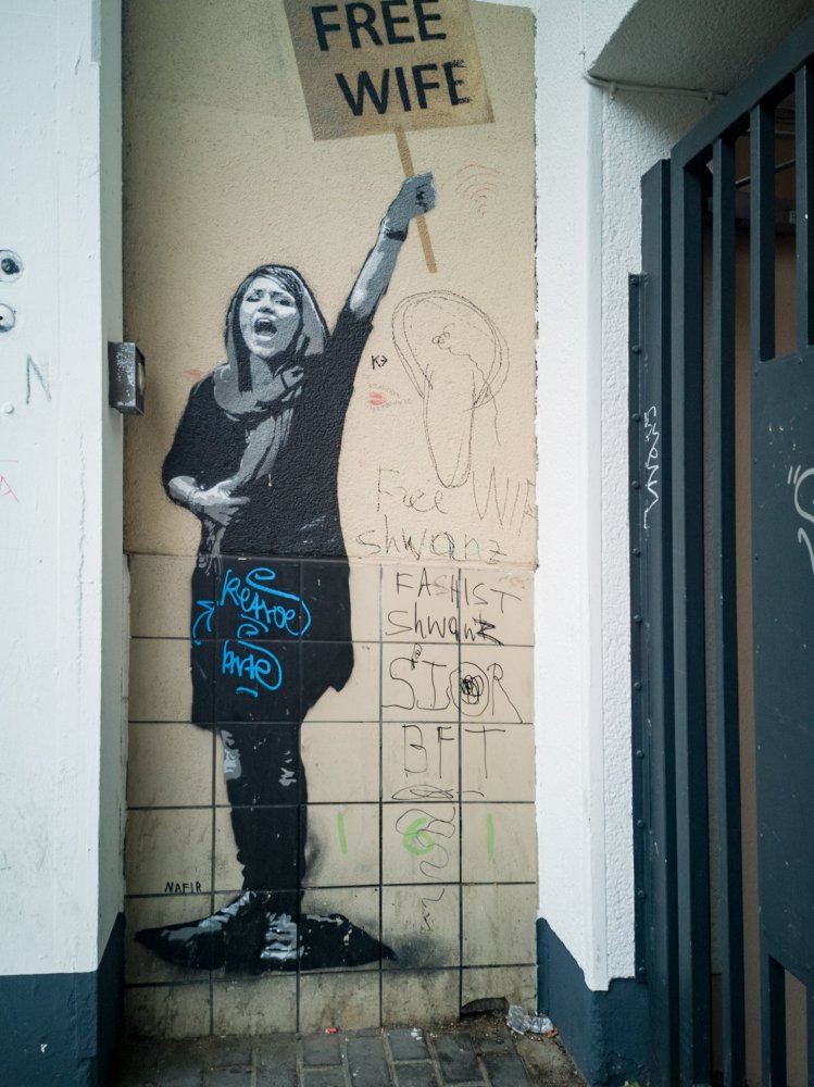 a person with graffiti on the side of a building