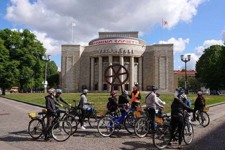 a group of people riding on the back of a bicycle