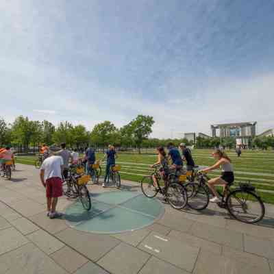 a group of people riding on the back of a bicycle
