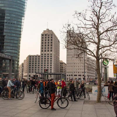 a group of people riding on the back of a bicycle