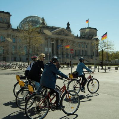 a group of people riding on the back of a bicycle