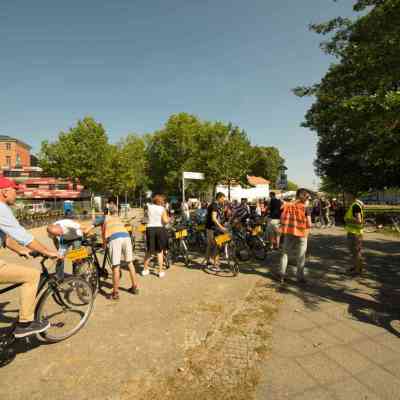 a group of people riding on the back of a bicycle