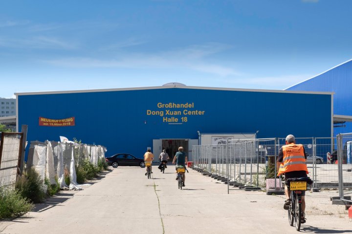 a group of people walking in front of a building