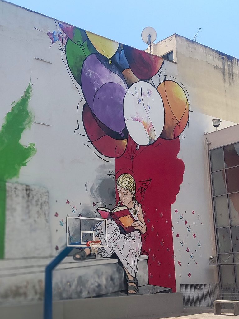 Another reading girl in Athens. Maybe this is a subtle hint to Banksy's famous girl with a ballon?