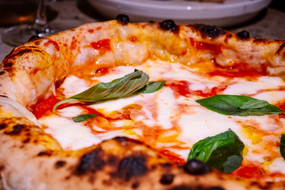 a close up of a plate of food with a slice of pizza