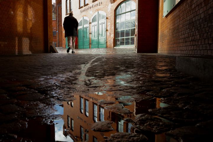 a wooden bench in front of a brick building