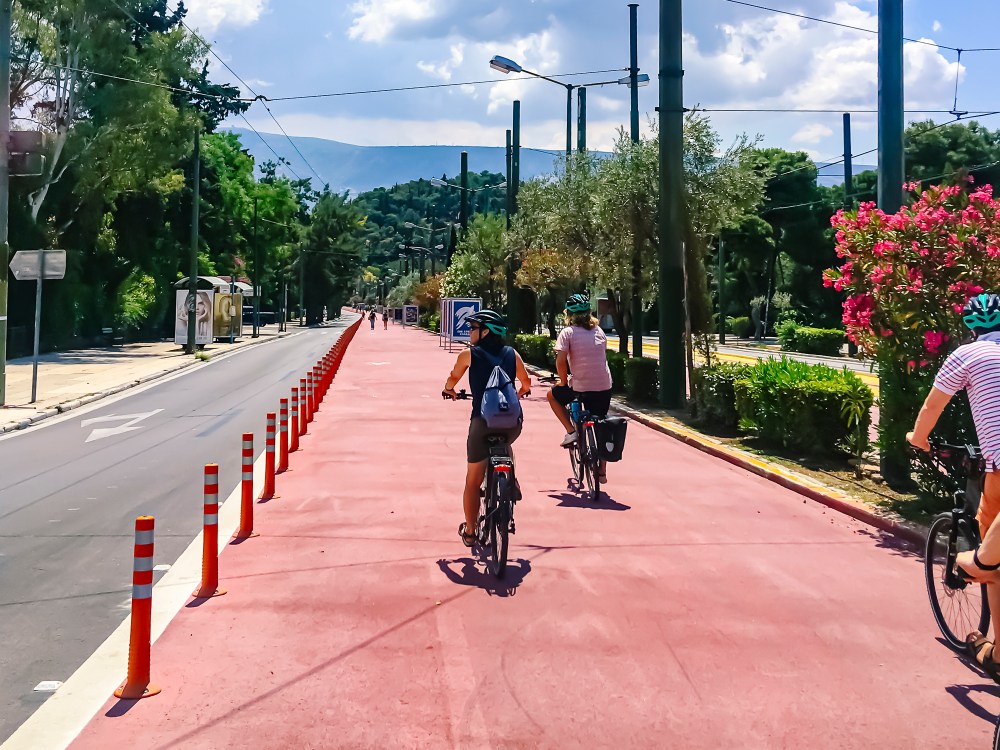 a group of people riding bikes down a street