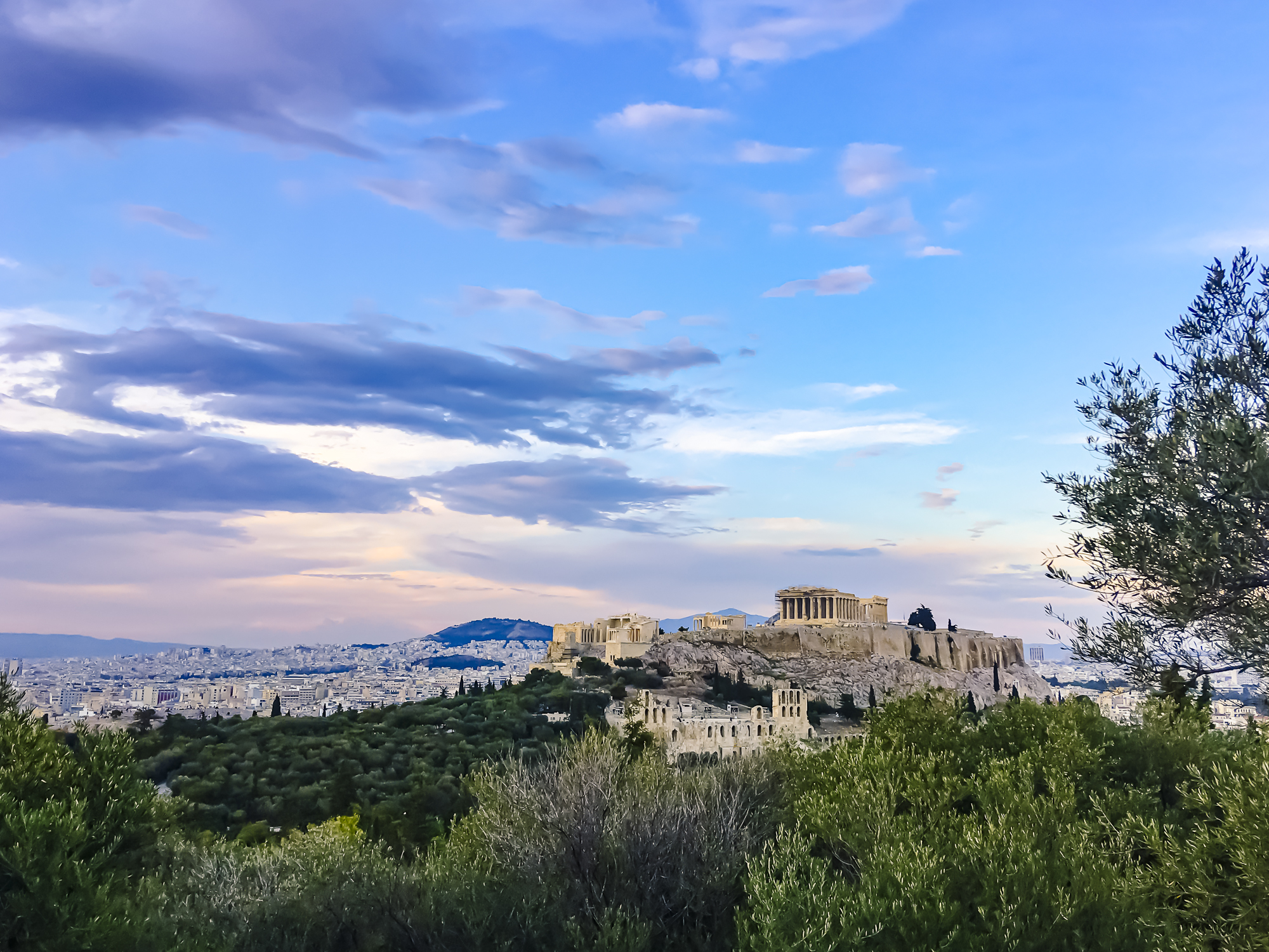 Athens_Sunset-1 a castle on top of a grass covered field