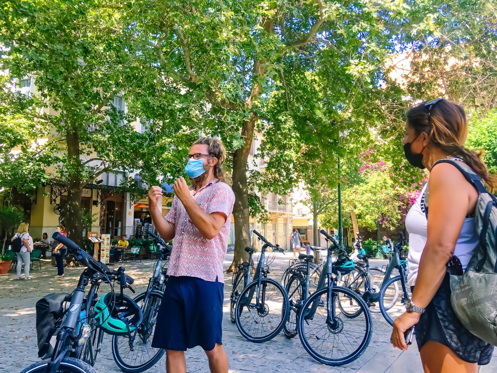 a group of people standing next to a bicycle