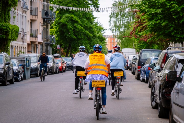 a group of people riding motorcycles on a city street