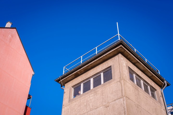 a tall brick tower with a clock on the side of a building