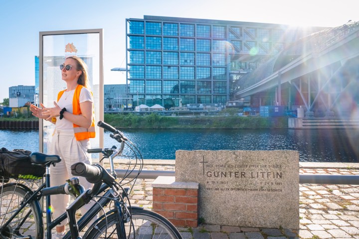 a person with a bicycle in front of a building