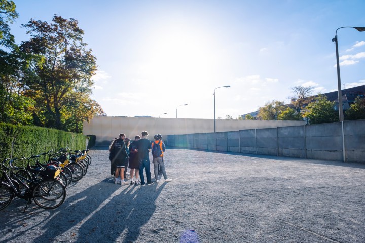 a group of people riding on the back of a bicycle