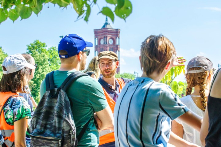 a group of people standing around a baseball field
