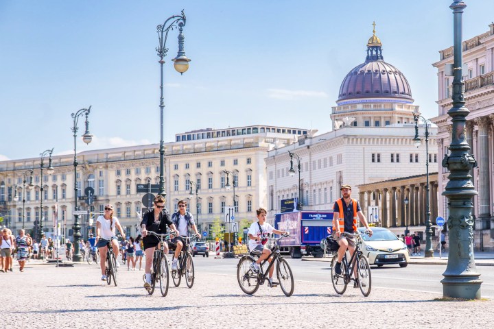 a group of people riding on the back of a bicycle