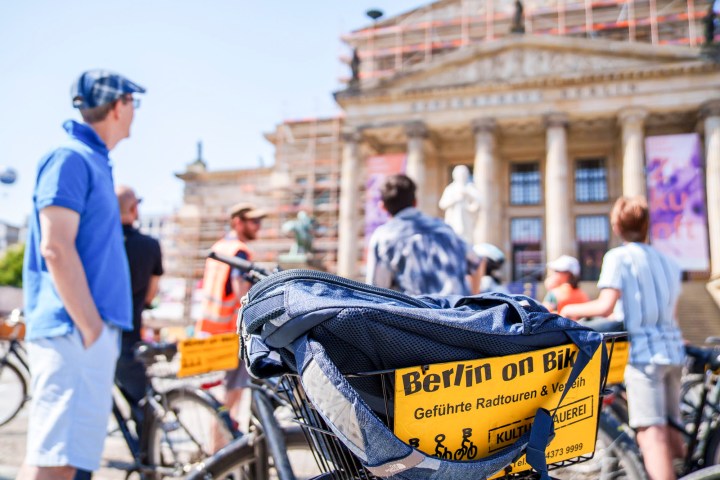 a man riding on the back of a bicycle