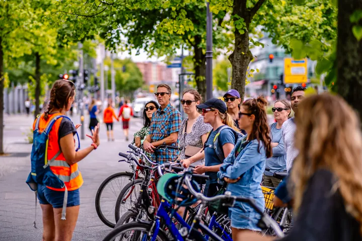 a group of people riding on the back of a bicycle