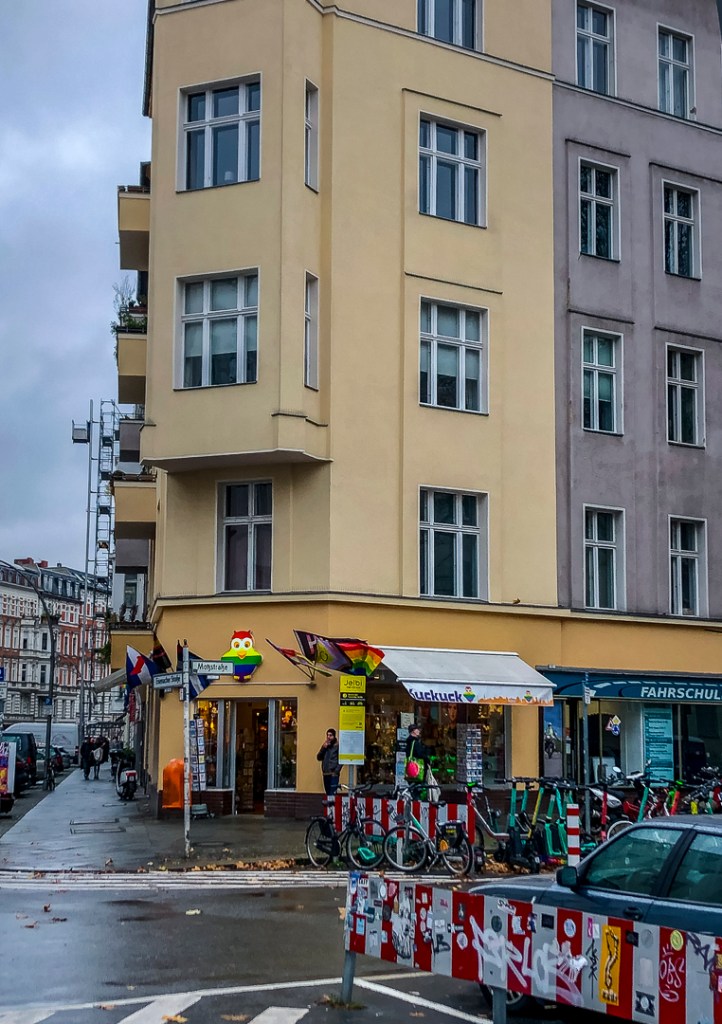 a street corner in the Schöneberg neighbourhood in Berlin with rainbow signs and flags
