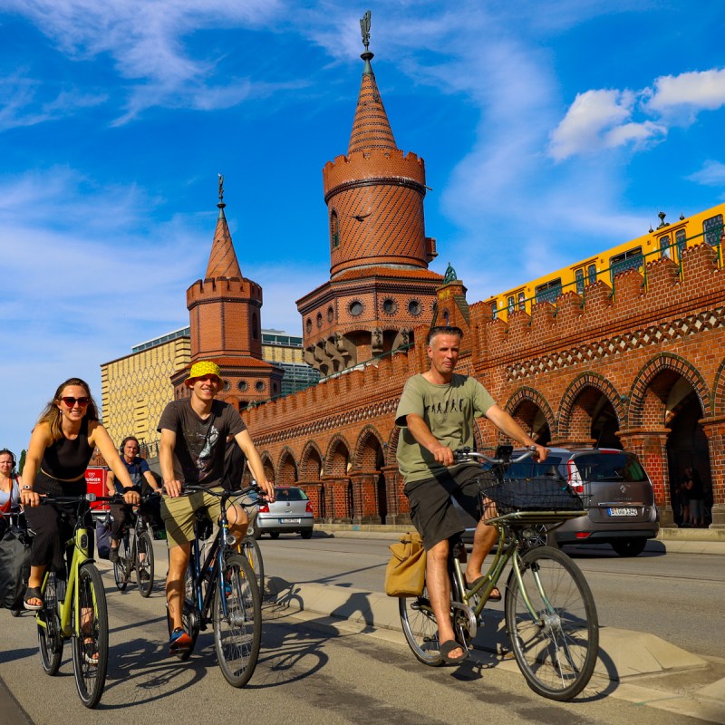 a group of people riding on the back of a bicycle